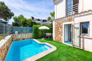 a swimming pool in the backyard of a house at Bahamas 2 in Son Serra de Marina