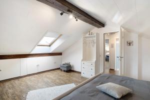 a attic bedroom with a bed and a skylight at Schwarzwaldtani - Dörfle in Ottersweier