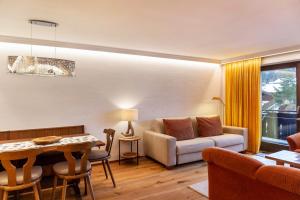 a living room with a couch and a table at Haus Excelsior Top 29 in Seefeld in Tirol +19 photos