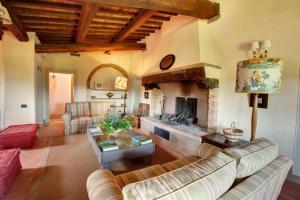 a living room with a couch and a fireplace at Villa Il Conventino in Mercatale Val Di Pesa