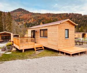 a wooden cabin with a porch and a deck at NATURAMA Glockenalm in Fischbachau