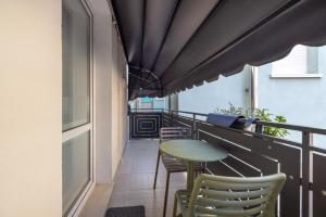 a balcony with a table and chairs on it at Appartamento Bettin in Caorle +17 photos