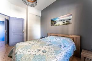 a bedroom with a bed and a picture on the wall at Appartement des Cedres in Uzès +17 photos