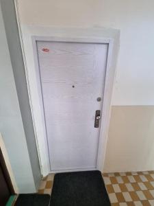 a white door in a room with a checkered floor at Apartmán Sárka Brezno in Brezno