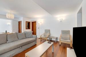 a living room with a couch and two chairs at Estoril Close To The Sea in Estoril