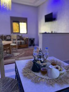 a table with a tea set on top of it at Oasis apartment in Ouarzazate