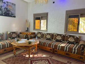 a living room with two couches and a table at Oasis apartment in Ouarzazate +18 photos
