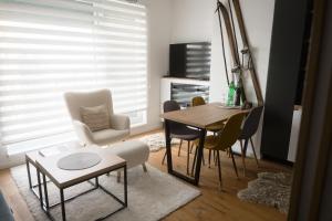 a living room with a dining room table and chairs at Apartment - Vucica in Bjelašnica