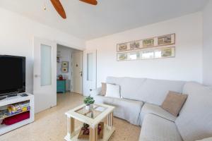 a living room with a white couch and a tv at Aguadulce Beach in Aguadulce