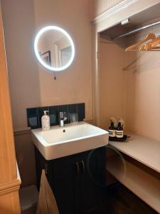 a bathroom with a white sink and a mirror at Little House Harrogate in Harrogate
