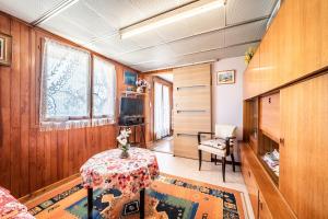 a room with a table and a chair in a room at Les Hortensias in Reignier