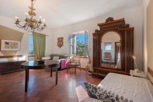 a living room with a table and a mirror at Agriturismo Monte Pu' in Castiglione Chiavarese