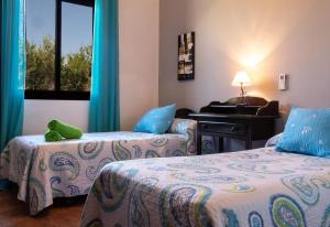 a hotel room with two beds and a piano at Casa Rural Villa Lucrecia in La Lantejuela +30 photos