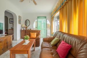 a living room with a couch and a table at Casa Haza Rila - Piscina y Wifi in Cómpeta