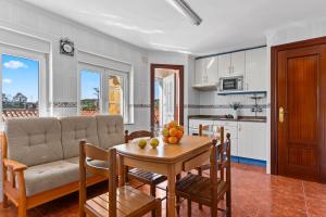 a living room with a table and a couch at El Rincón De Pocholo in Lastres