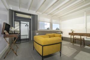 a living room with a yellow couch and a table at Casa Saidera in Playa Blanca