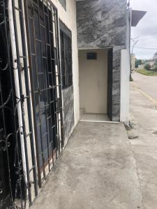 an entrance to a building with black iron gates at Hospedaje Maluli suit 4 in Santa Elena