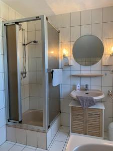a bathroom with a shower and a sink at Ferienhaus am See in Haselünne +37 photos