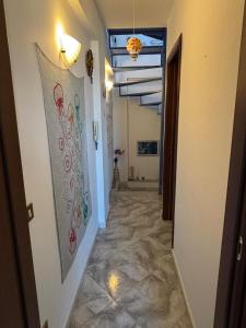 a hallway with a painting on the wall at Sumarè in Isola delle Femmine