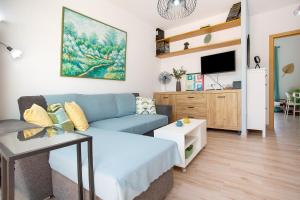 a living room with a couch and a tv at Alojamiento El Ocaso in Puerto del Rosario
