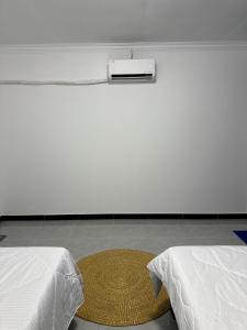 two beds in a room with a rug between them at David's Hostel & Restaurant in Koh Rong