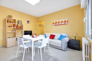 a living room with a table and a couch at Maria I Apartment with private pool in Torrevieja