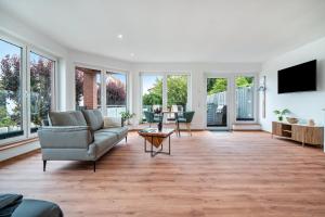 a living room with a couch and a table at Apartment an der alten Bäckerei in Feldberg