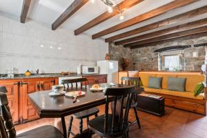 a kitchen and dining room with a table and chairs at Lorences D in Caunedo +15 photos