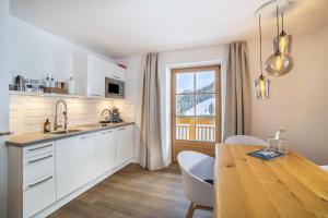a kitchen with a table and a dining room at Mountain Residence Kasern Nr 2 in Predoi +14 photos