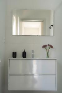 a white bathroom with a sink and a mirror at Casa Pitoresca - Refugio Esposende in Gemeses