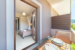 a dining room with a table and a view of a bedroom at Angel's Studio 4 in Agios Georgios Pagon