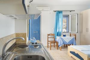 a kitchen with a sink and a table at Studios Ninemia Serifos 4 in Livadion