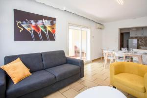 a living room with a couch and a table at Location La Londe in La Londe-les-Maures