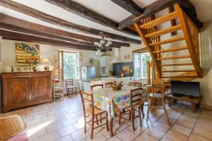 a kitchen and dining room with a table and chairs at La Maison De Tine in Cénac-et-Saint-Julien