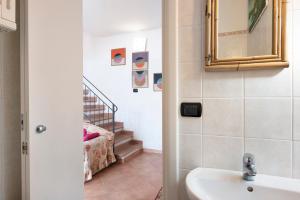 a bathroom with a sink and a staircase at Villetta Rosa in Lavagna
