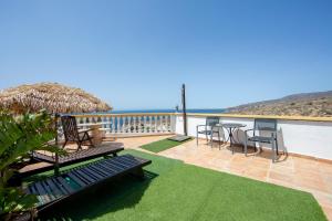 a patio with a table and chairs and the ocean at Vista al Mar Ainara in Almería