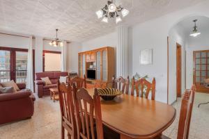 a dining room and living room with a table and chairs at Casa Abuela Maruca in Corralejo