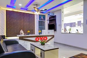 a living room with a couch and a table at Hotel O Aura Hotel Rajdhani Residency in Rānchī