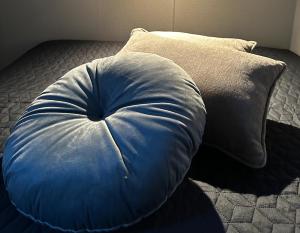 a large blue pillow sitting on a bed at Flyers Hotel in Keflavík