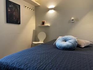 a blue pillow sitting on a bed in a room at Flyers Hotel in Keflavík