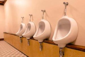 a row of four urinals in a bathroom at Grace Hostel - Chiang Rai in Chiang Rai +29 photos