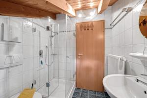 a bathroom with a shower and a toilet and a sink at Petrushof Ferienwohnung Hochplatte in Oberwössen +19 photos