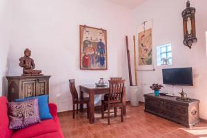 a living room with a red couch and a wooden table at Casa Sabina - Villa Perenquén in Guía de Isora