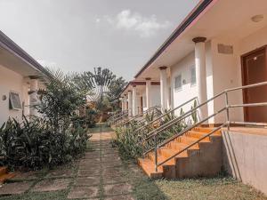 a building with stairs and plants in front of it at Hampton Resorts in Hohoe