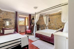 une chambre avec deux lits et une chaise dans l'établissement Casa do Eido da Devesa, à Bárrio 27 autres photos