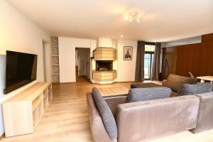 a living room with a couch and a television at Großes Ferienhaus in Siegen-Kreuztal auch für Monteure in Kreuztal