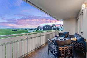 a balcony with chairs and a table with a view at Bauer Haug in Dietmannsried