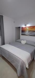 a bedroom with two beds and a painting on the wall at L'aurora in San Vito dei Normanni