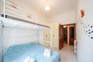 a bedroom with a blue bed and a bunk room at Villa Verde - 300m From Sea in Bordighera