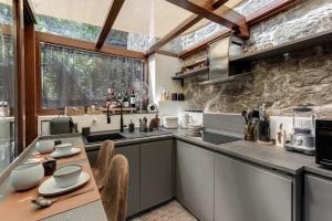 a kitchen with a table and chairs in a room at Luxury Country Retreat La Stallina in Londa